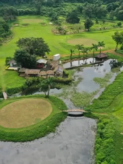 Another perspective from above, this image captures the relationship between our island green, the main course, and the nearby clubhouse facilities, all nestled within the natural landscape.