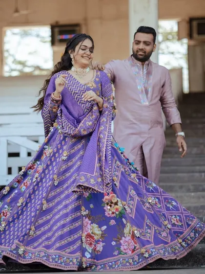 The bride and groom, with her beautiful floral hairstyle adding to the romance of the moment.