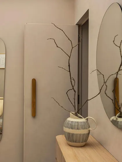 A detail from a treatment room in the 'Crème' wellness center. We used organic-shaped mirrors, warm wood accents, and a muted color palette to create a private, serene, and luxurious environment for clients.