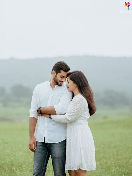 A simple and sweet portrait of a couple embracing in a green field, their connection being the sole focus of the image.
