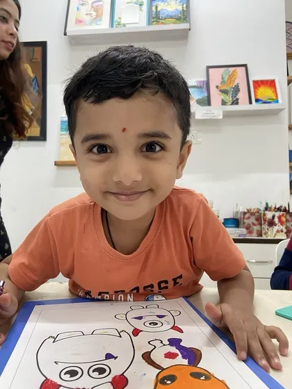 The bright smile of one of our youngest artists says it all. We create a welcoming space where even the littlest creators feel comfortable exploring colors and shapes.