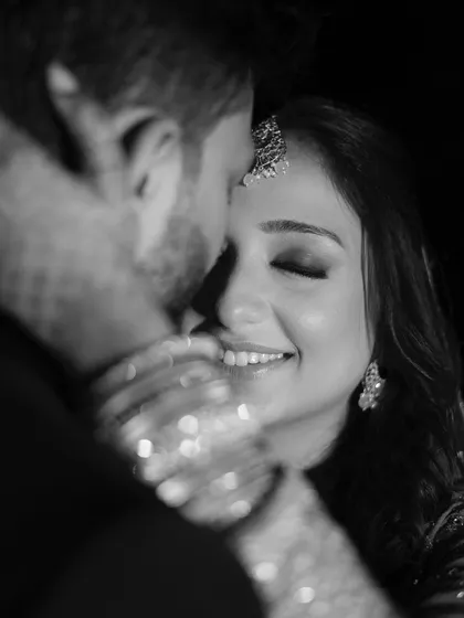 A timeless black and white close-up that captures the bride's joyful smile and the couple's embrace. This intimate shot is full of love and happiness.