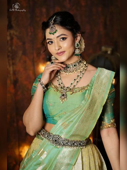 A classic pose from the ethnic wear photoshoot, highlighting the elegant drape of the half-saree style lehenga.