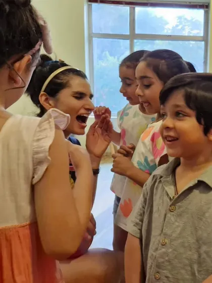 A close-up of me interacting with students. These moments of connection are where we build the trust needed for children to express themselves freely.
