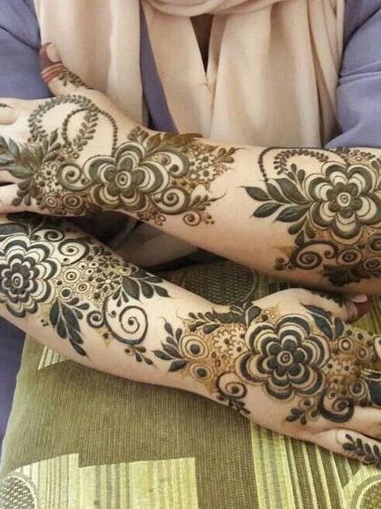 Two hands adorned with bold, beautiful floral patterns, perfect for a festive celebration.