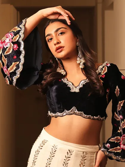 This look is about modern festive glamour. I paired a soft, glowing makeup look with a contemporary embroidered velvet blouse, creating a perfect balance for a sangeet or reception party.