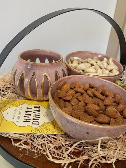 For Diwali, I create these curated gift hampers. This one features my 24-carat gold-coated blushing pink bowls and a matching tealight holder, perfect for festive gifting.