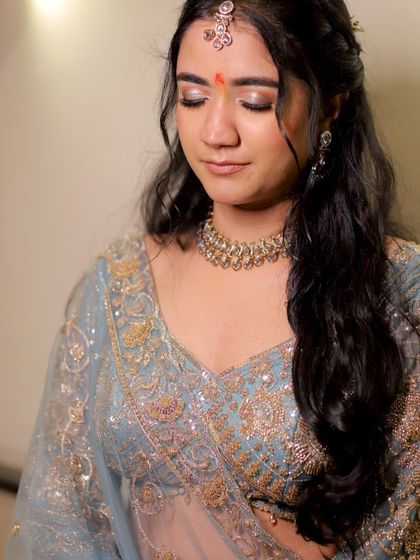 A close-up of Bhumika's engagement makeup. The soft, shimmery eyeshadow and perfectly defined brows create a dreamy, romantic look.