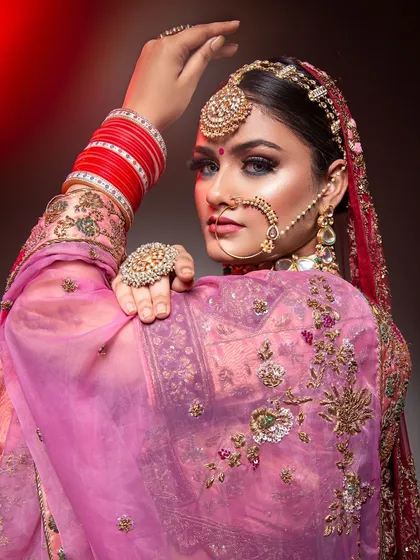 A bold and beautiful bridal look for the modern bride. This look features dramatic eyes, glowing skin, and traditional jewelry, creating a perfect blend of contemporary style and classic elegance.