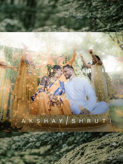 A romantic and joyful Haldi portrait of a couple sharing a moment amidst a shower of flower petals.