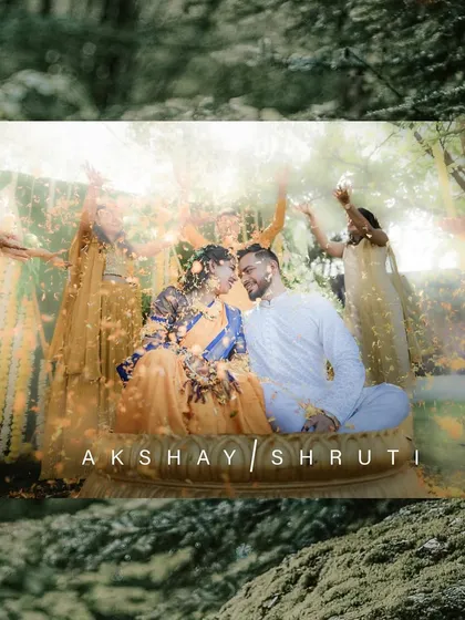 A romantic and joyful Haldi portrait of a couple sharing a moment amidst a shower of flower petals.