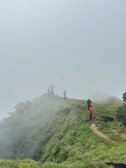 Trekkers on the misty ridge of Kumara Parvatha.