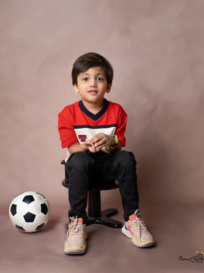 A future football star. This simple and classic portrait of a young boy with his soccer ball captures his personality and interests perfectly.