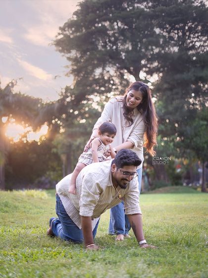 Let's play! I encourage families to interact naturally, and sometimes that means giving piggyback rides on all fours. This playful scene shows the fun and laughter that make for unforgettable family portraits.