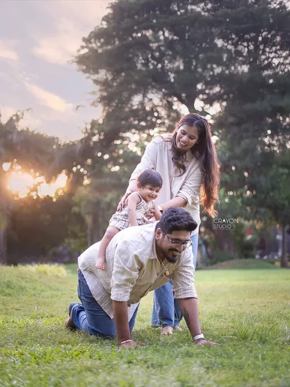 Let's play! I encourage families to interact naturally, and sometimes that means giving piggyback rides on all fours. This playful scene shows the fun and laughter that make for unforgettable family portraits.