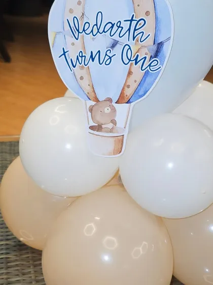 It's the little details that count. This custom table centerpiece features a hot air balloon cutout with the birthday boy's name, perfectly matching the main theme of the party.