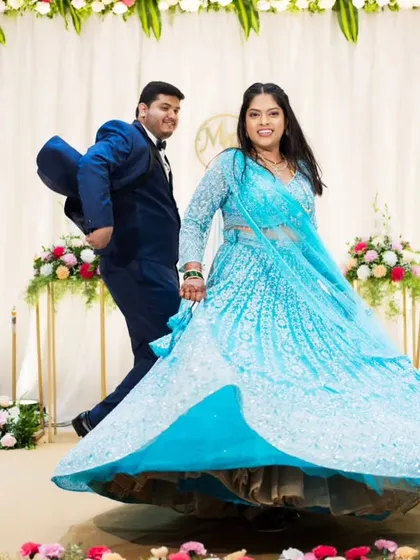 A fun, candid moment on the dance floor, capturing the bride's twirling lehenga and the couple's happy energy.