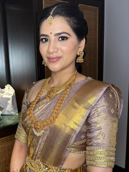 A picture of elegance for her engagement. The makeup is simple and refined, with a focus on glowing skin and a neutral lip, letting her natural beauty shine.