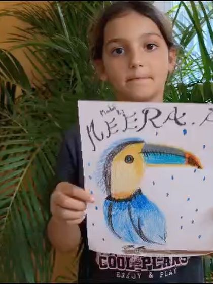 A still from the video of Meera presenting her rainy-day toucan artwork.