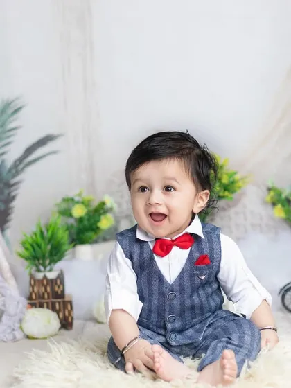 A dapper little man in a three-piece suit! This six-month photoshoot is full of charm and personality.