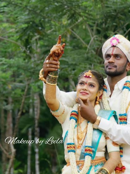 A candid outdoor shot of a newly married couple. The bride's makeup is fresh and natural, designed to last through the entire wedding day, from the ceremony to the outdoor photoshoot.