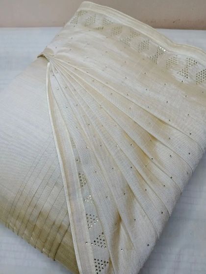 This off-white saree with delicate sequin work is perfect for an elegant evening. Pre-pleating ensures the drape is as graceful as the saree itself.