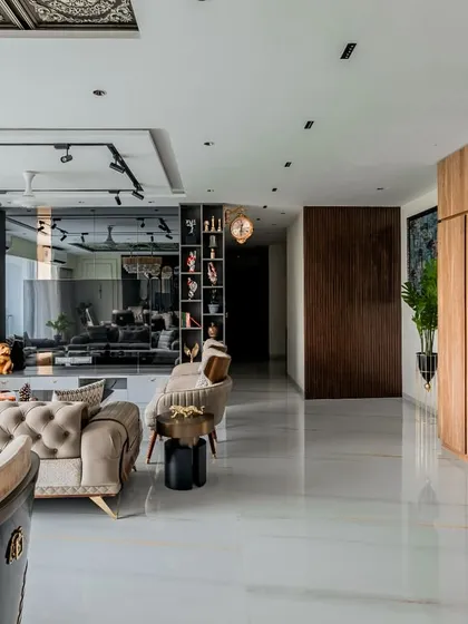 This perspective shows the grand scale of the living space, from the custom display cabinetry to the expansive windows. The layout is designed to be open and airy, promoting easy conversation and movement throughout the area.