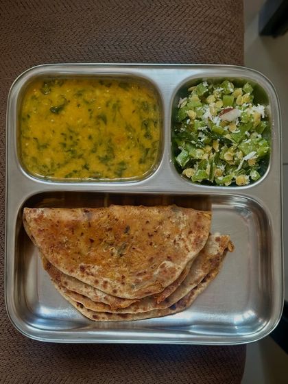 A hearty stuffed cauliflower paratha served with dal methi and sautéed ridge gourd with coconut.