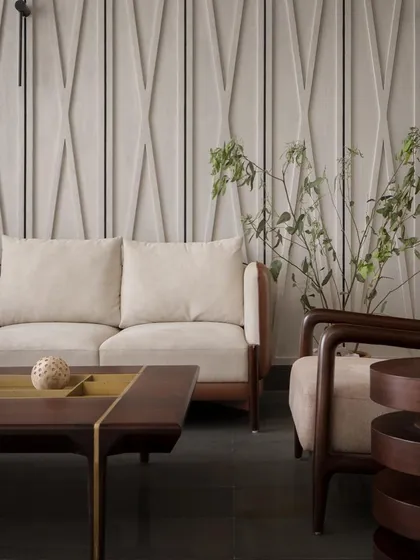 A detail of the living room, where clean geometric lines are softened by the warm tones of oakwood and plush upholstery. It's a silent symphony of sophistication.