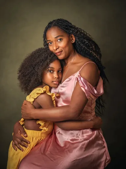 The embrace between a mother and daughter is a powerful symbol of love and protection. This portrait of Deborah and Naomi is all about their connection, their gazes telling a story of deep affection and a shared journey.