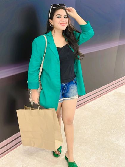 A full-length view of my shopping day outfit. The green blazer adds a pop of color and structure to an otherwise simple shorts and top combination.