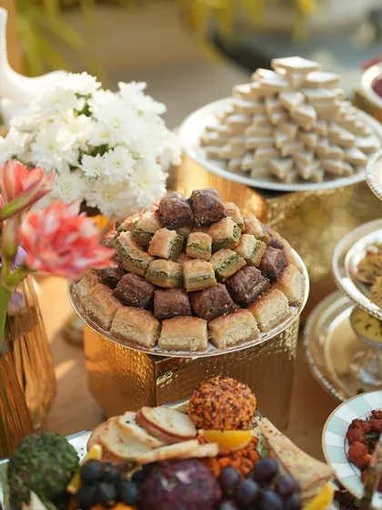 A tower of assorted baklava, a sweet and nutty highlight of the dessert section of the grazing table.