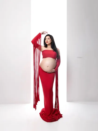 Motherhood is a statement of power and beauty. I love using bold colors and artistic concepts, like this vibrant red maternity look, to create portraits that are as unique and strong as you are.