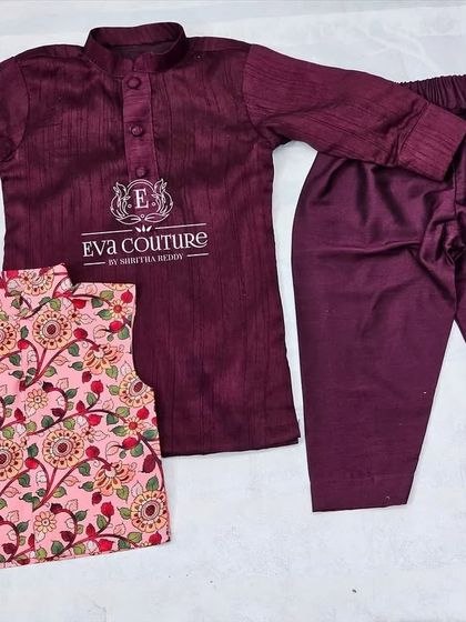A similar three-piece set in a rich maroon color, also with a pink printed Nehru jacket.