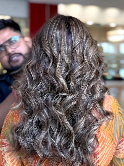 A shot of me with the client, showing off her beautiful balayage with brown and blonde highlights.