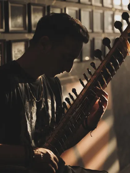 A silhouetted shot from the 'Mastery' series, with light filtering in. It captures the introspective and dedicated nature of a musician's life.