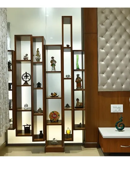 A custom-designed wooden display unit with integrated backlighting, created to showcase the client's collection of artifacts and sculptures.