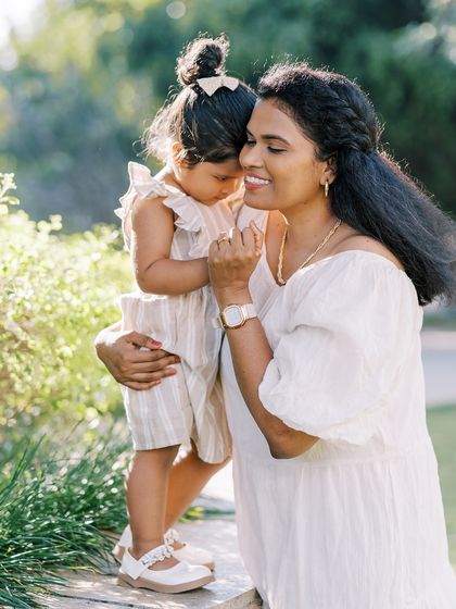 A mother and daughter sharing a quiet, intimate moment. The soft lighting and their close connection are beautiful.
