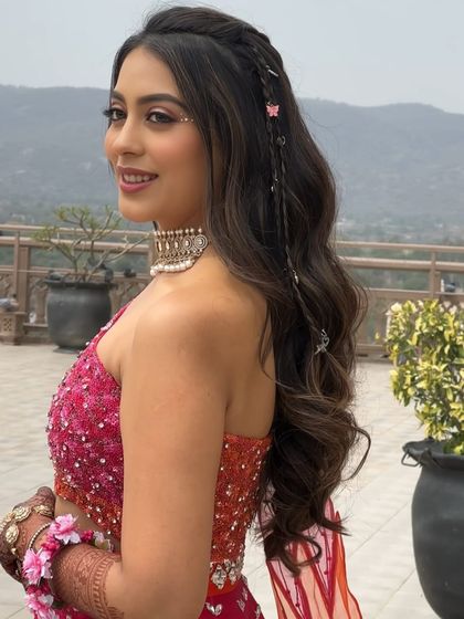 A portrait of the client enjoying her carnival event. The wavy, accessorized hairstyle is perfect for the festive atmosphere.