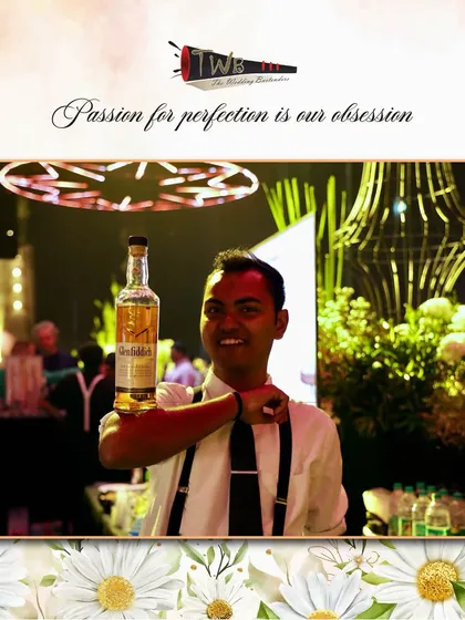 A bartender proudly holds up a bottle of Glenfiddich, one of the many premium brands we offer.