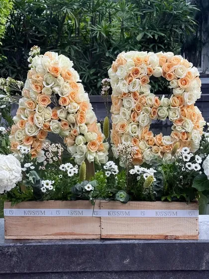 I create bold, personalized statements with flowers. These custom floral monograms, crafted from hundreds of fresh peach and cream roses, are a stunning way to celebrate a wedding, anniversary, or special milestone.