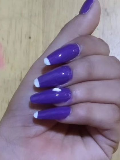 A deep purple gel polish on long, coffin-shaped nails. I added a modern twist with small, white half-moon details at the tips and a tiny white heart accent.