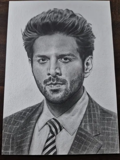 A sharp and stylish portrait of Bollywood actor Kartik Aaryan, perfect for any fan of his work.
