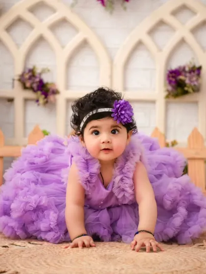 A lavender dream. This little girl in her fluffy purple dress looks like a flower blooming in a magical garden.