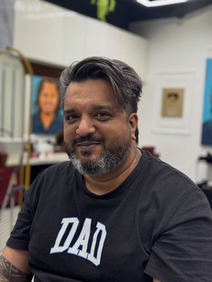 The client looking happy and confident with his new, premium salt and pepper style.