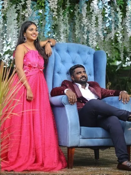 A formal couple's look featuring a vibrant pink gown and a rich, red velvet blazer. This setup shows how we coordinate outfits for a sophisticated and elegant pre-wedding photoshoot.