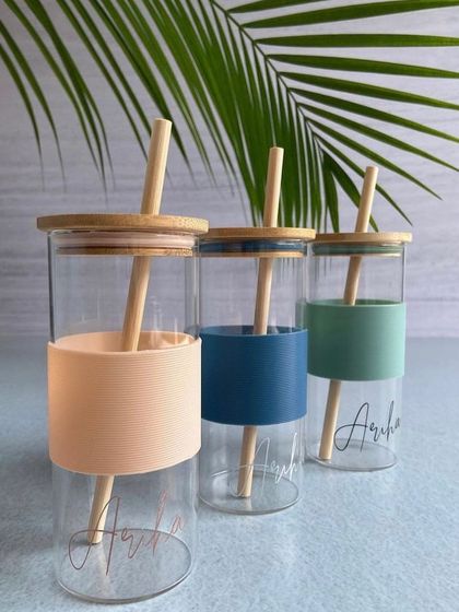 Our can-shaped glass tumblers with a bamboo lid and straw are a sustainable and stylish choice. The silicone sleeve adds a pop of color and a comfortable grip.