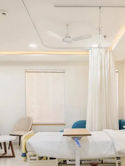 This patient room at Sarvodaya Hospital is designed for comfort and care. The space includes modern medical equipment seamlessly integrated with a calming interior, featuring warm wood tones and soft lighting.