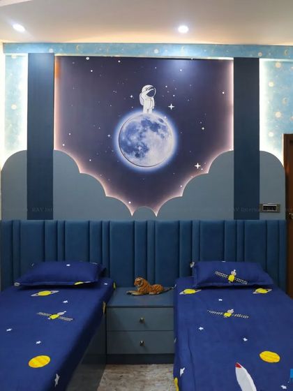 A close-up of the space-themed accent wall in the kids' room, with an astronaut on the moon and backlit clouds.