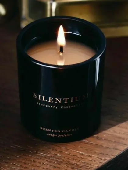 This black jar scented candle, shown here lit and creating a warm ambiance, is an example of the sleek and modern options I offer for bulk and corporate orders. The "Silentium" branding is an example of custom labeling.